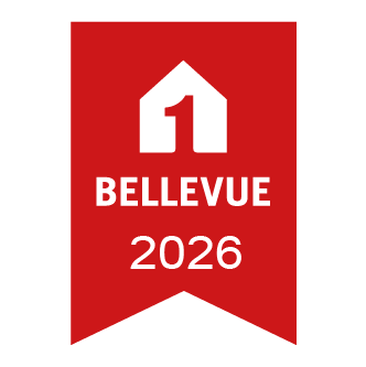 Rotes Bandsiegel mit weißem Haus-Icon und Schriftzug Bellevue 2026