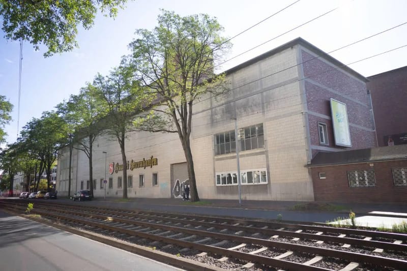 Backsteingebäude der Brauerei Herrenhausen mit Straßenbahnschienen davor